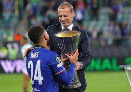 Aleksander Ceferin presents the trophy to Reece James