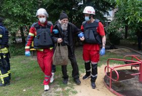Medics are carrying an elderly man