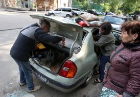 Car owners clean up broken glass
