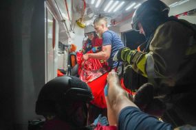Doctors provide assistance to a seriously injured man in an ambulance in Kharkiv