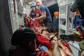 Doctors provide assistance to a seriously injured man in an ambulance in Kharkiv