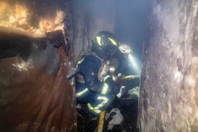 Rescuers work in a damaged residential building in Kharkiv