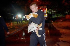 A man with a cat in his arms