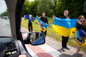 People along the road meet buses with prisoners of war
