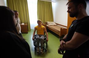 Forum participants communicate with a boy