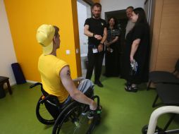 Forum participants communicate with a boy