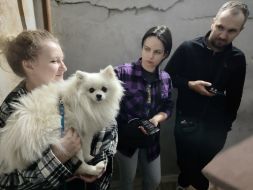 A woman with a white Pomeranian dog hides in a shelter of the dormitory of NAU (now Kyiv Aviation Institute) in Kyiv