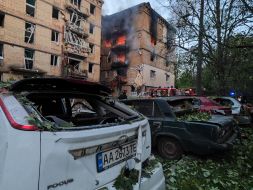 A destroyed entrance to a residential building as a result of a direct hit by a missile in the Solomianskyi district of Kyiv
