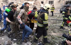 Providing assistance to a State Emergency Service employee near a residential building destroyed as a result of a direct missile hit in the Solomianskyi district of Kyiv