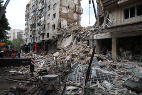 A destroyed entrance to a residential building as a result of a direct hit by a missile in the Solomianskyi district of Kyiv