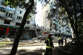 A destroyed entrance to a residential building as a result of a direct hit by a missile in the Solomianskyi district of Kyiv
