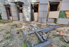 Broken door and damaged building facade after a combined attack in the Shevchenkivskyi district of Kyiv