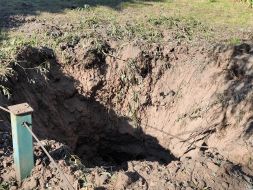 A crater on the lawn after a combined attack in the Shevchenko district of Kyiv