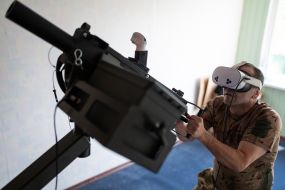 Military personnel train to shoot down aerial targets on a special simulator