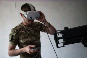 Military personnel train to shoot down aerial targets on a special simulator