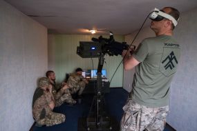 Military personnel train to shoot down aerial targets on a special simulator
