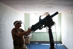 Military personnel train to shoot down aerial targets on a special simulator