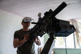 Military personnel train to shoot down aerial targets on a special simulator