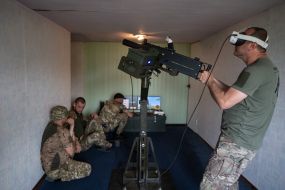 Military personnel train to shoot down aerial targets on a special simulator