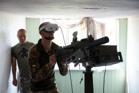 Military personnel train to shoot down aerial targets on a special simulator