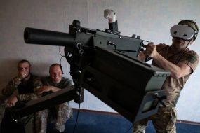 Military personnel train to shoot down aerial targets on a special simulator