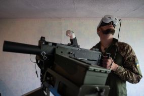 Military personnel train to shoot down aerial targets on a special simulator