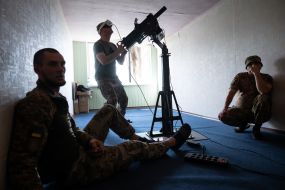 Military personnel train to shoot down aerial targets on a special simulator