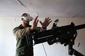 Military personnel train to shoot down aerial targets on a special simulator