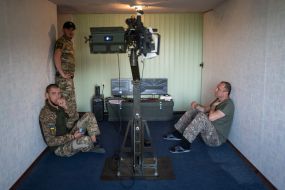Military personnel train to shoot down aerial targets on a special simulator