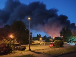 The sky is covered in smoke following a massive nighttime attack in the Sviatoshynskyi district of Kyiv