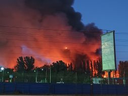 The sky is covered in smoke and flames from fires following a massive nighttime attack in the Sviatoshynskyi district of Kyiv