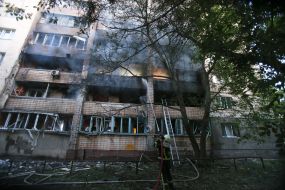 Rescuers extinguish a fire in a residential building after a massive nighttime attack in the Svyatoshynskyi district of Kyiv