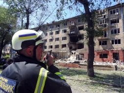 A rescuer works at the site of damage to residential buildings after a massive nighttime attack in the Svyatoshynskyi district of Kyiv