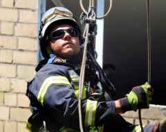 A rescuer works at the site of damage to residential buildings after a massive nighttime attack in the Svyatoshynskyi district of Kyiv