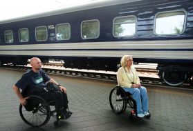 People in wheel chairs near the first inclusive carriage