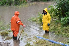 State Emergency Service workers pump water into the sewer in Lviv