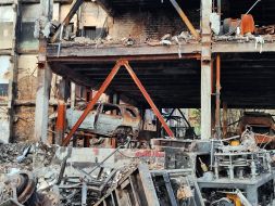 A destroyed house and a burned-out car after massive shelling in the Svyatoshynskyi district of Kyiv