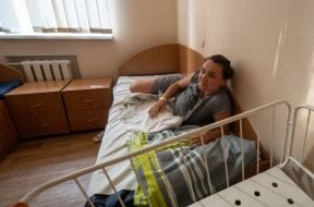 A woman in a maternity hospital damaged by shelling