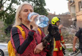 Resident of a house damaged by shelling