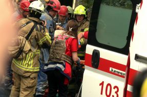 Rescuers carry a victim of shelling to an ambulance