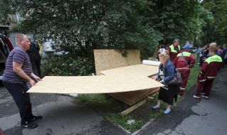 Люди несуть листок фанери