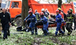 Rescuers carry the body of a deceased person