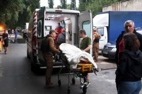 Rescuers carry a victim of shelling to an ambulance
