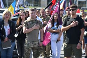 People honor the memory of fallen servicemen of the Airborne Assault Troops of the Armed Forces of Ukraine on a street in Lviv