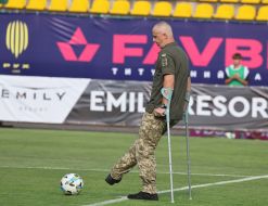 A soldier makes a symbolic kick at the ball