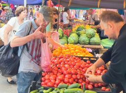 People buy vegetables at the market