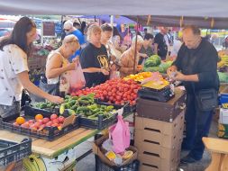People buy vegetables at the market