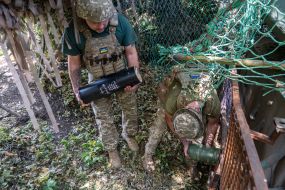 Artillerymen prepare a 2S3 Akatsiya howitzer for firing