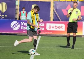 The military officer makes a symbolic kick on the ball