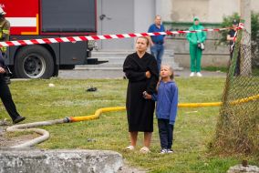 People near the house hit by a Russian drone